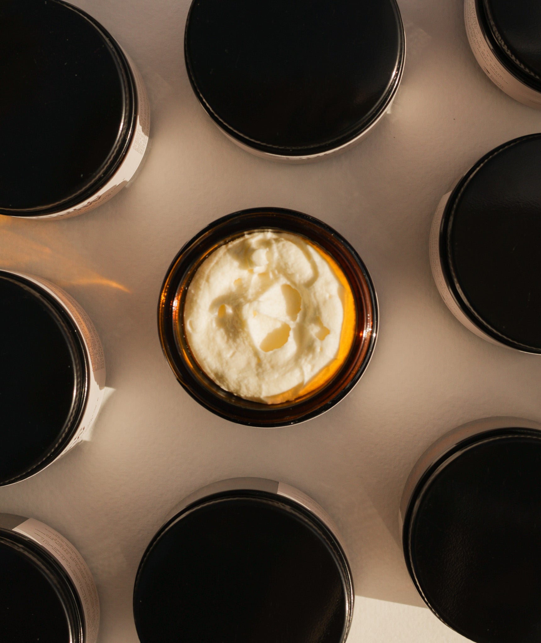Top-down view of an open jar of Bare Glow Tallow