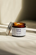 Bare Glow Tallow Balm jar open in the sunlight