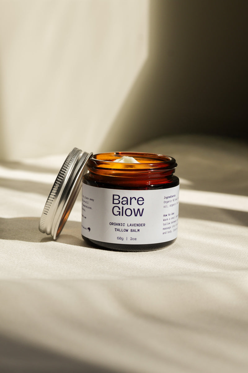 Bare Glow Tallow Balm jar open in the sunlight