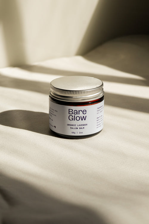 Closed jar of 'Bare Glow' balm on a beige surface with soft shadows