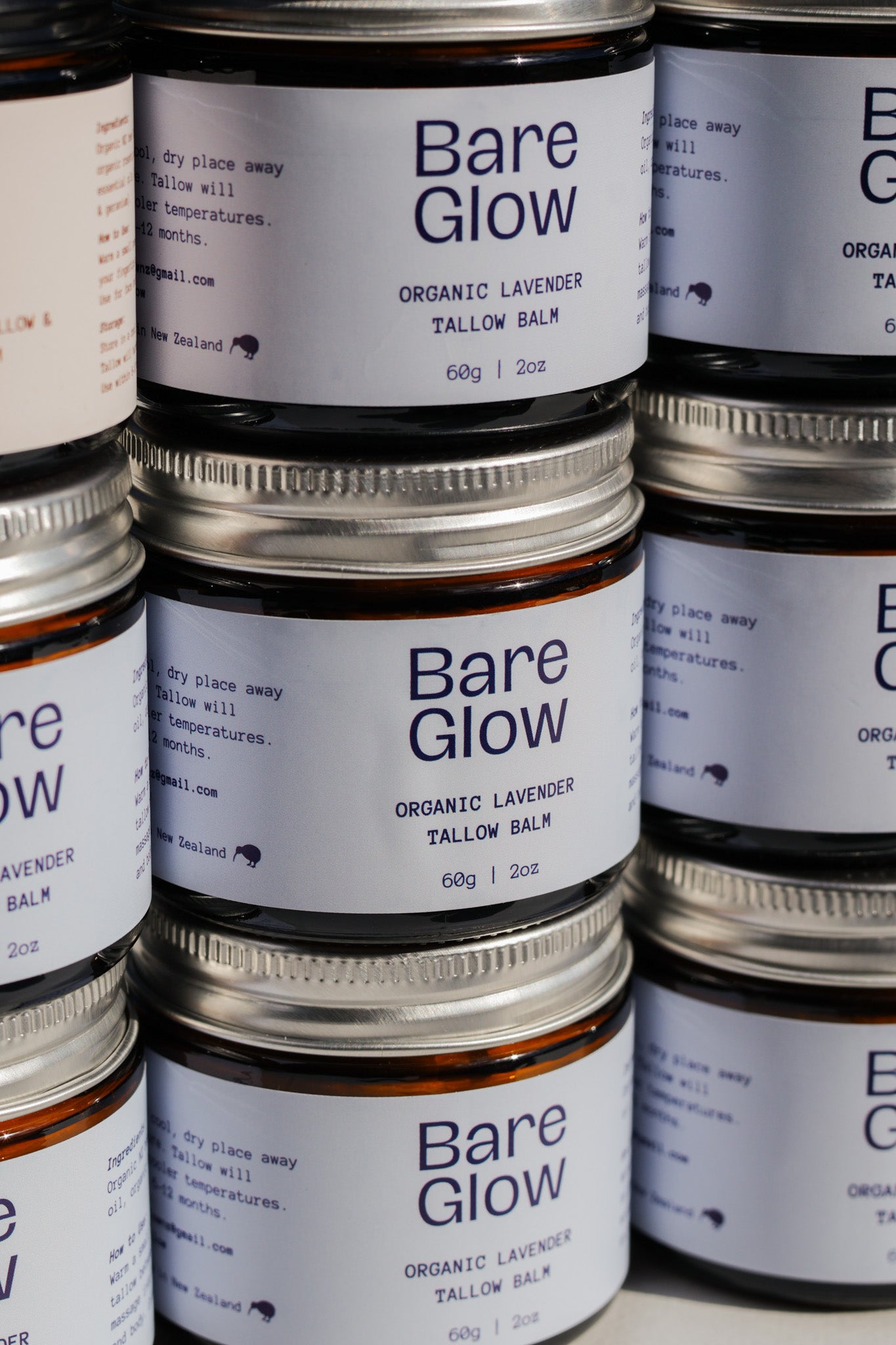 Bare Glow organic lavender tallow balm jars stacked on a white background